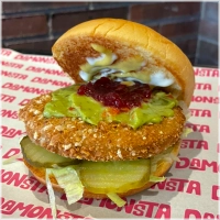 Krokante avocadoburger op onze potato bun met sla, augurk, guacamole, mango relish, rode bieten relish, American Mustard, American White Sauce.